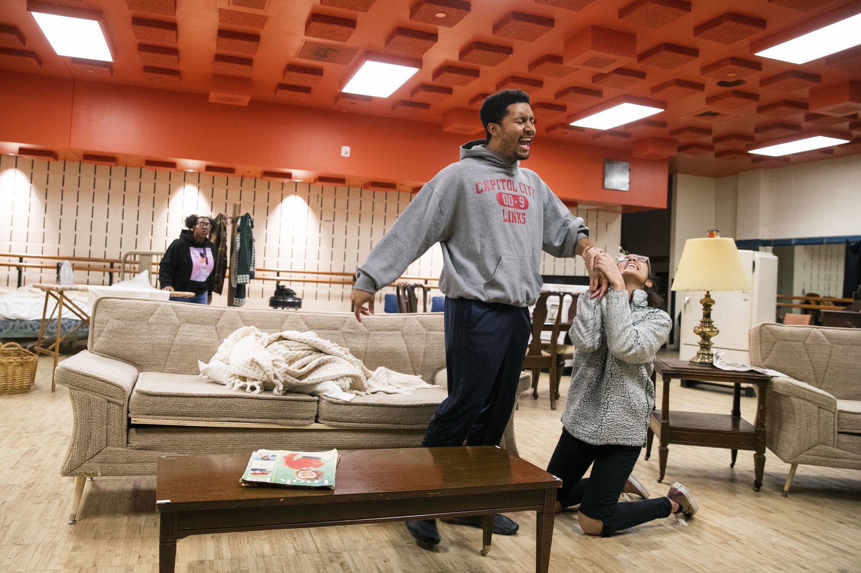 David Terrell Green performs as Walter Younger and Olivia Howard performs as Beneatha Younger.